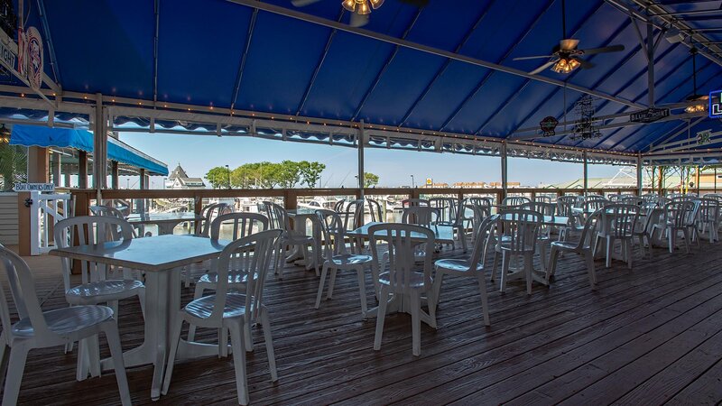Outdoor dining patio seating area with view of the dock